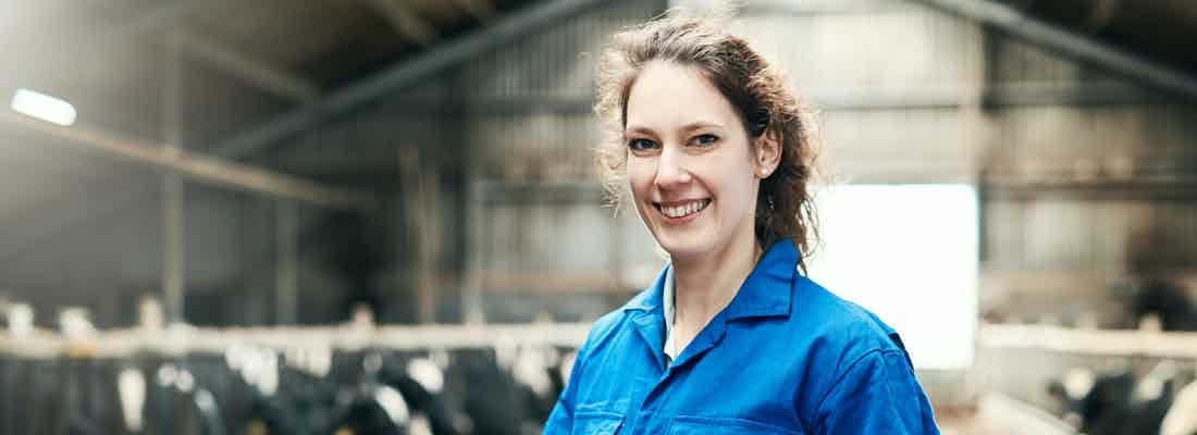 Woman on farm in blue boiler suit