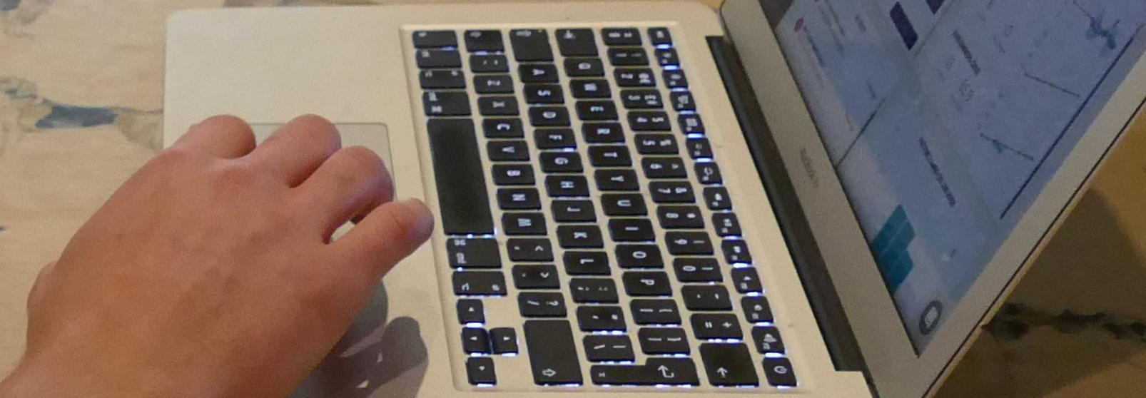 Laptop with hand typing