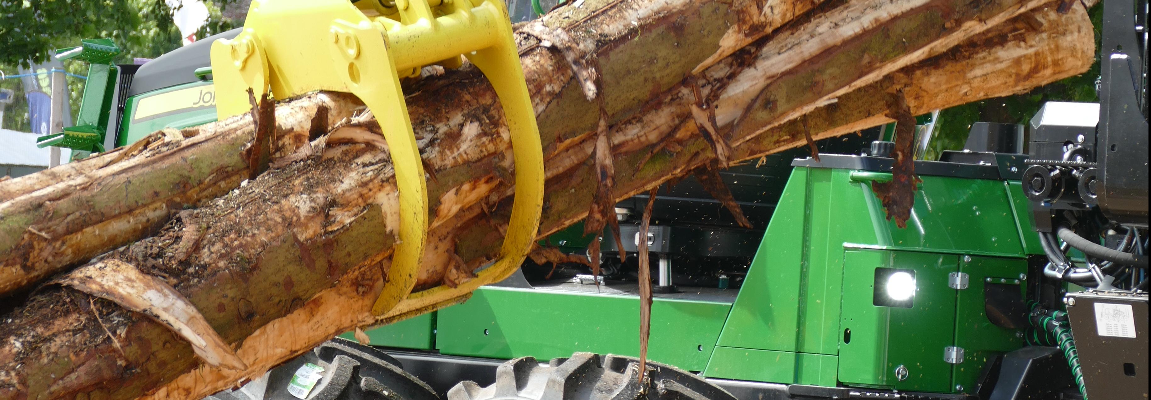 Machinery lifting logs