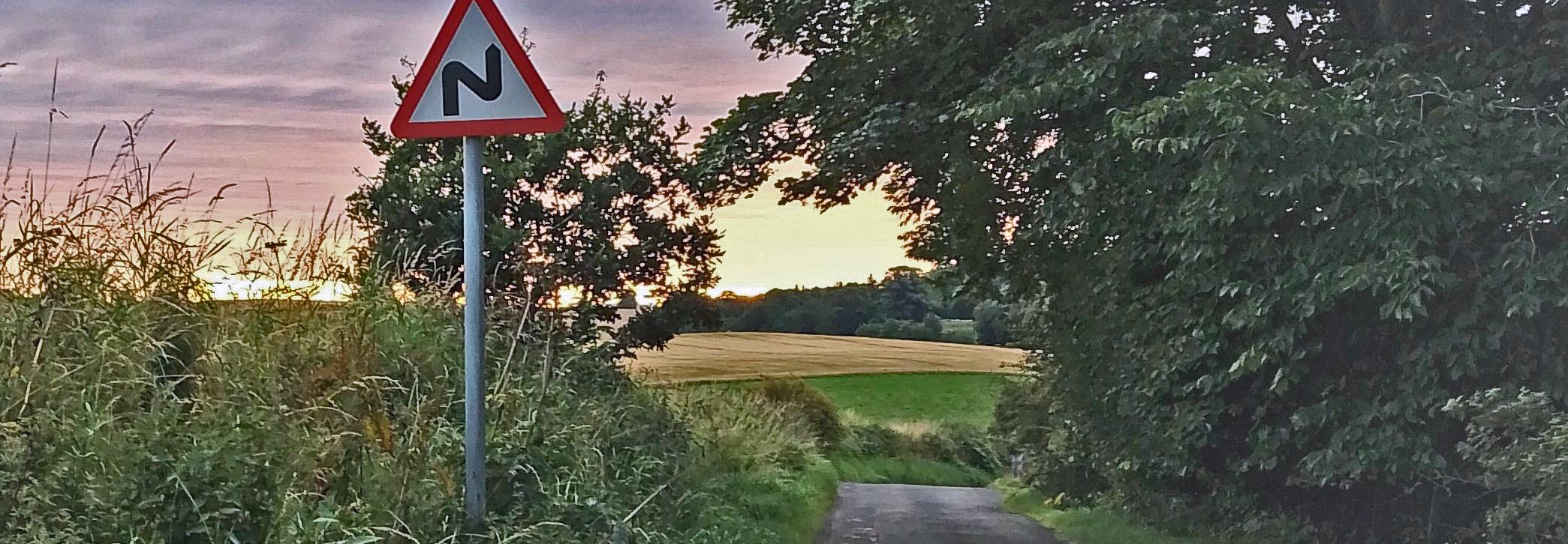 Road sign with countryside and road