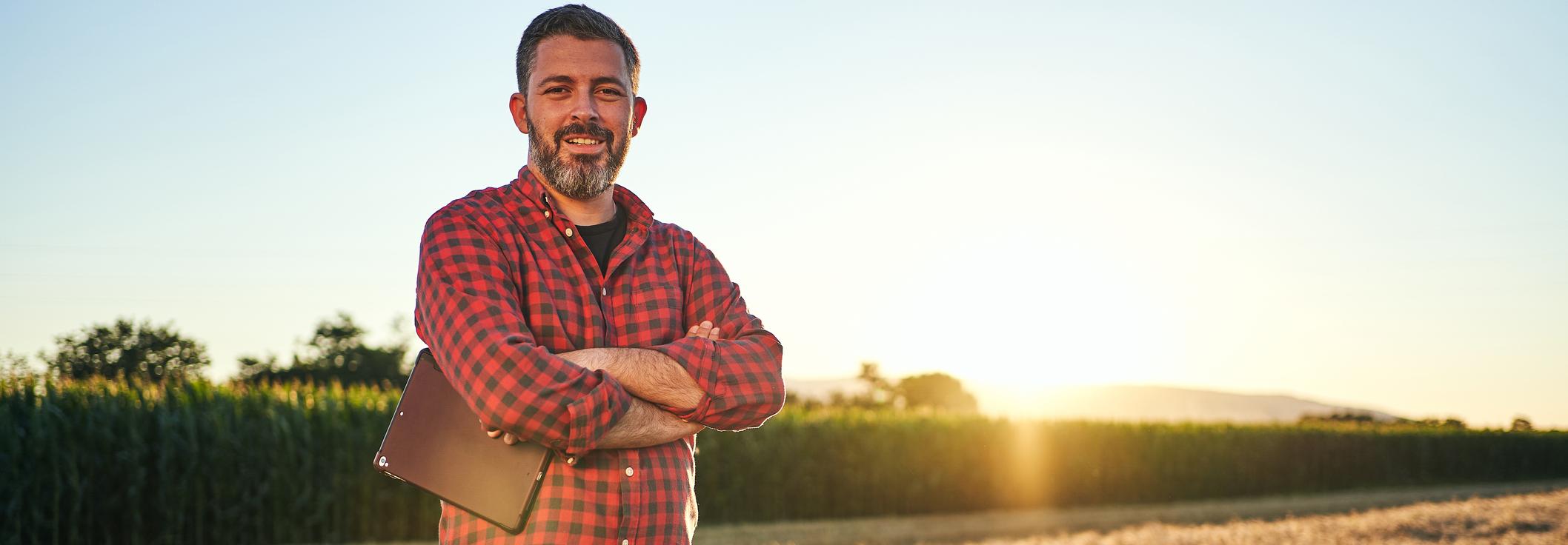 Agronomist in field of crops with tablet