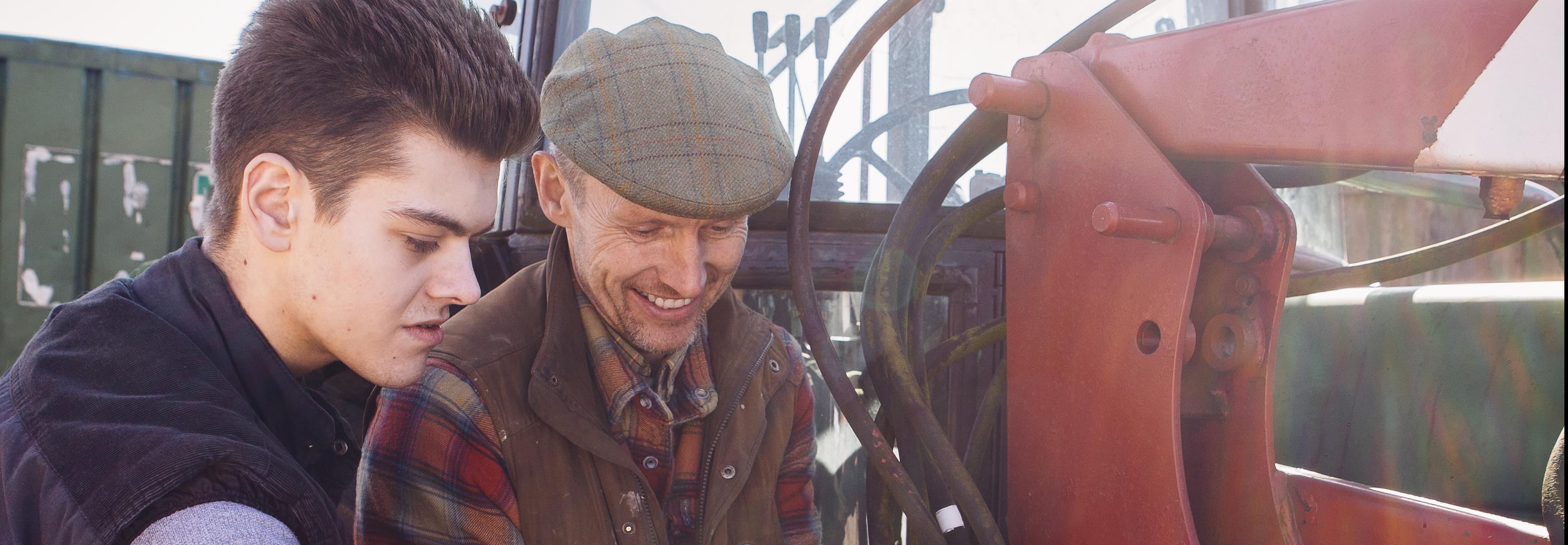 Two men working on a tractor