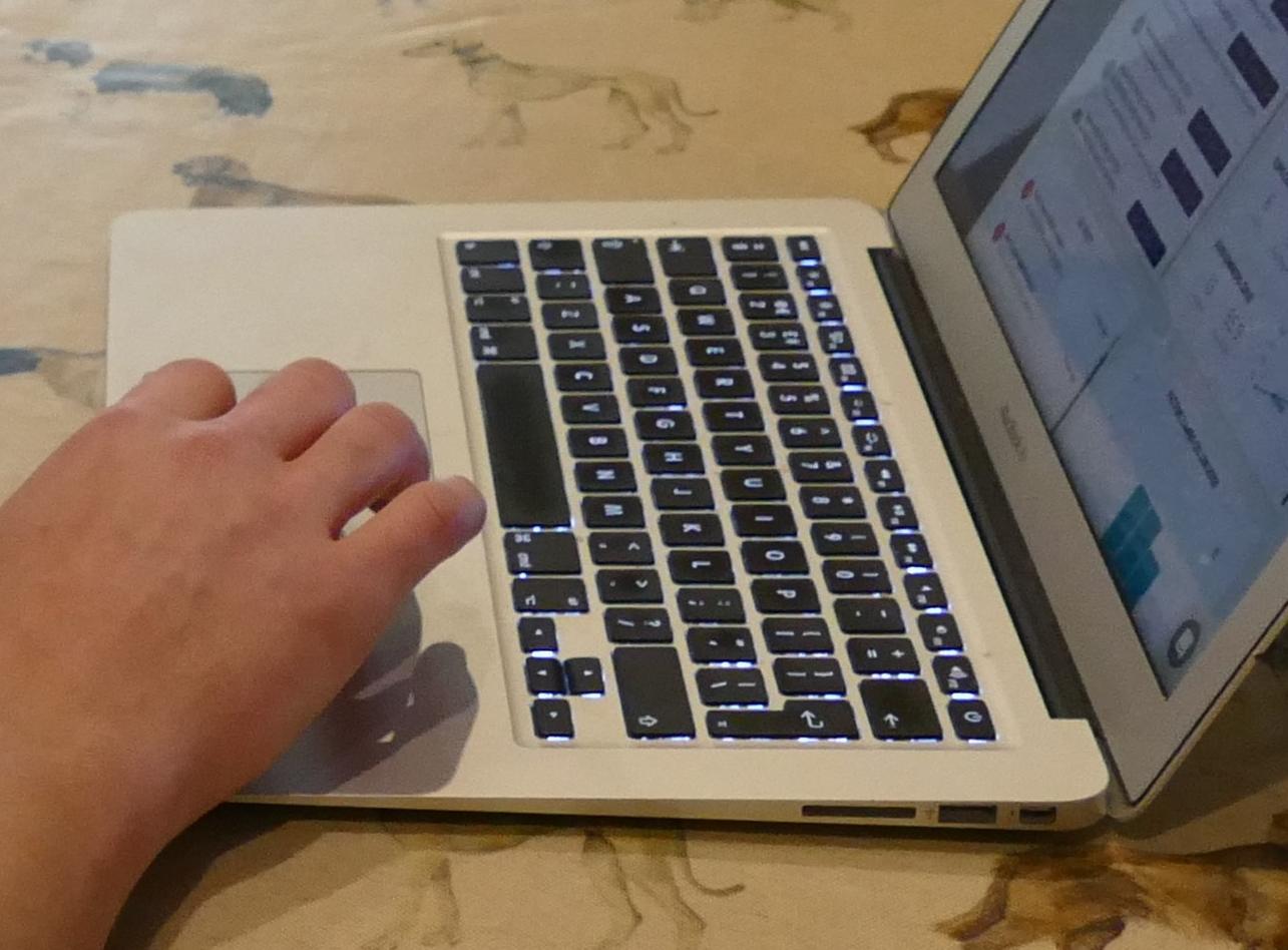 Laptop with hand typing