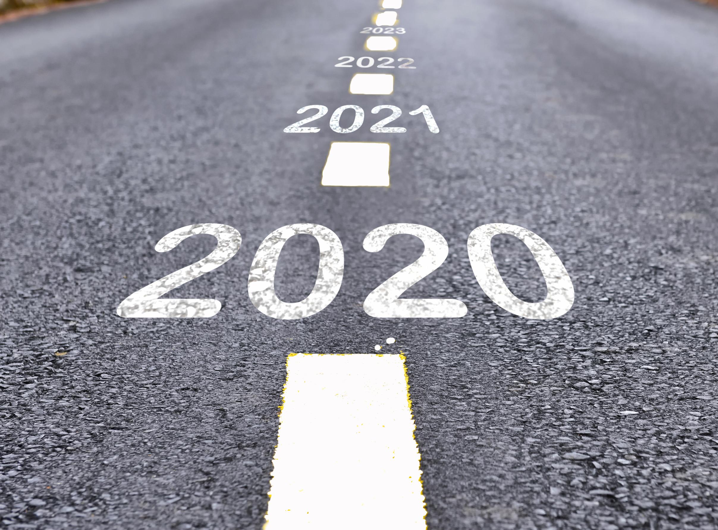 Road with 2020 and 2021 painted white on it into distance