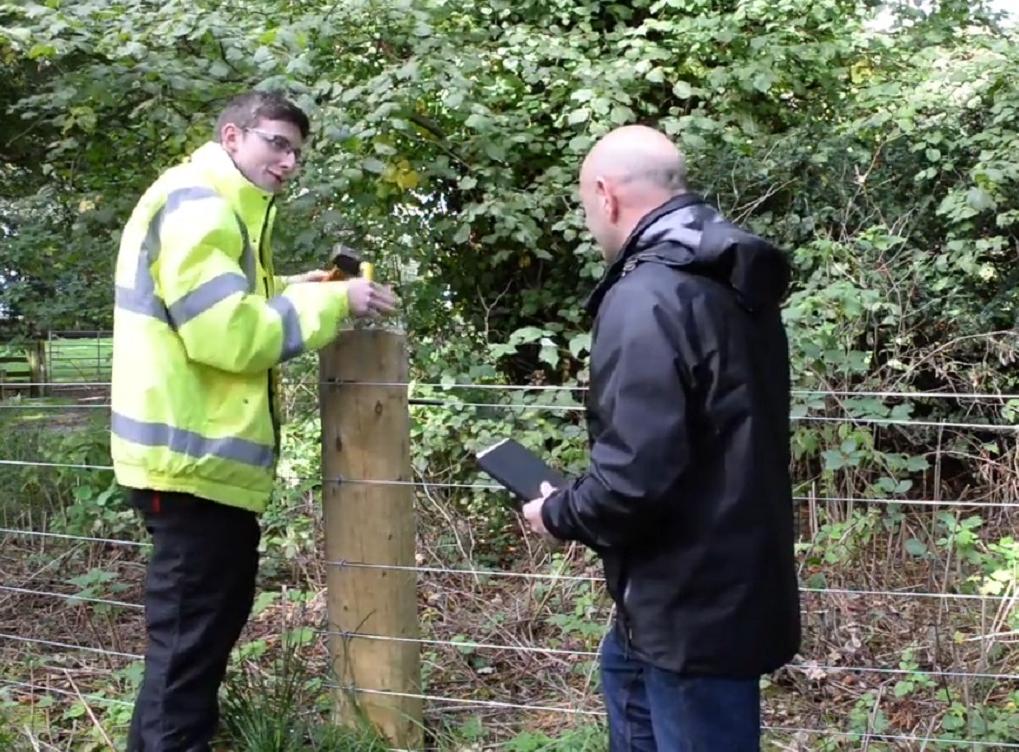 Apprentice in rural skills speaking to assessor