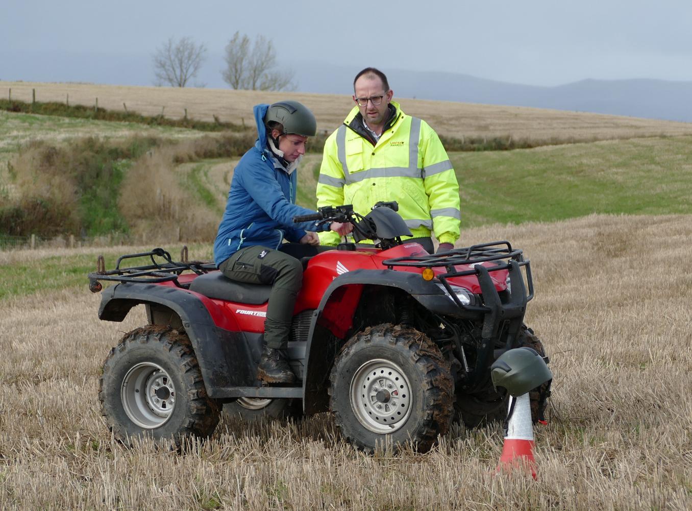 Woman on quad bike with instructor