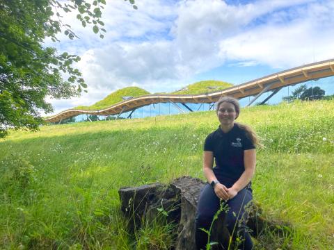Brodie Linklater sitting in grassland at The Macallan Distillery