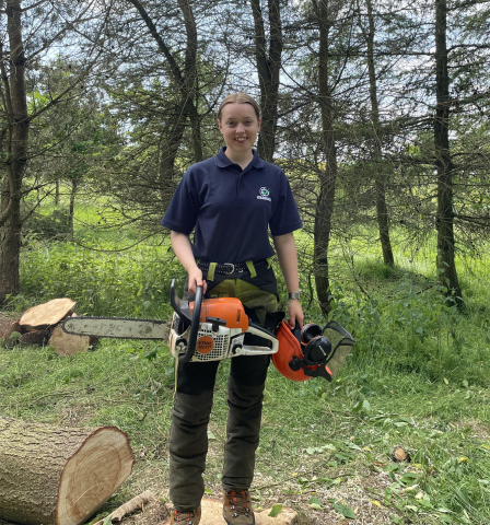 Hannah Munro with chainsaw working in rural Scotland