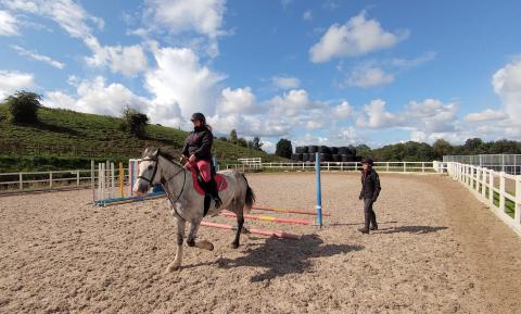 Horse riding in school with instructor