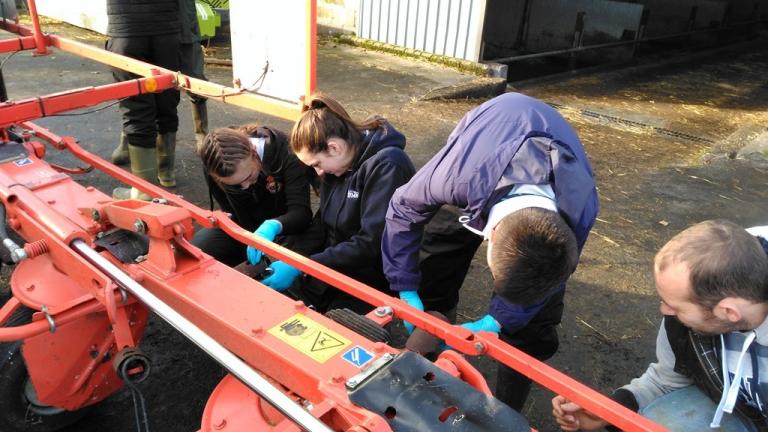School pupils learning about farm equipment