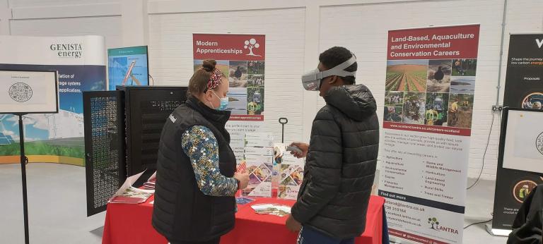 Pupil using VR goggles at careers event